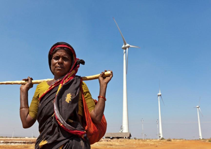 Woman standing in front of wind turbines Image: TIGR2ESS